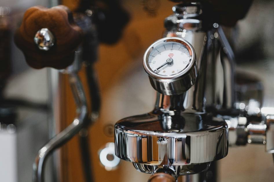 Kitchen pressure cooker with steam and fresh ingredients on counter